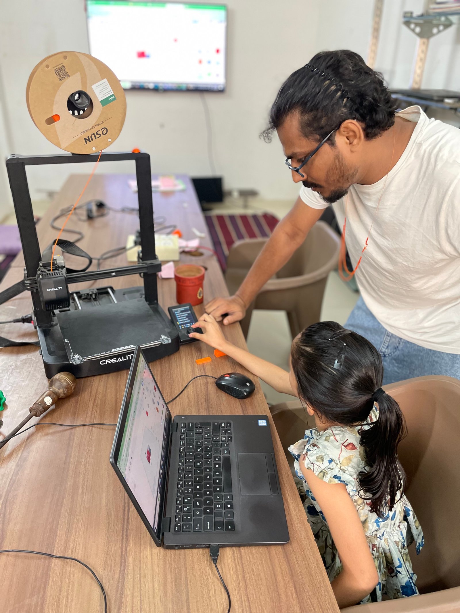 Two boys collaborating on a robotics circuit at ArCoBotics