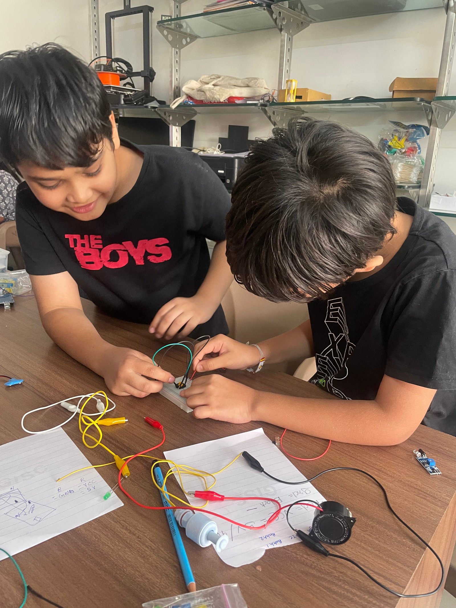 Instructor teaching a young girl about electronics at ArCoBotics